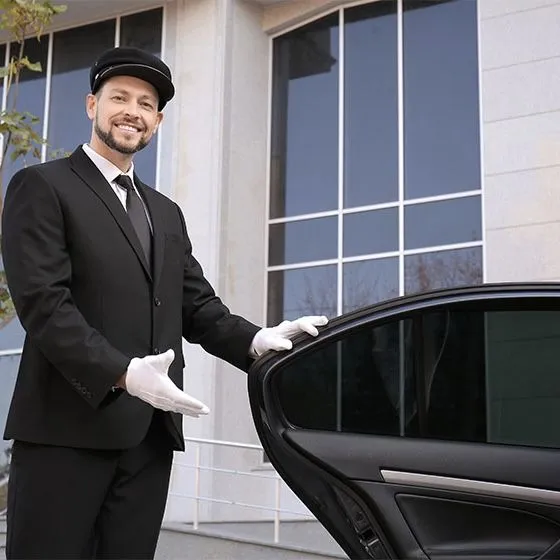Elegant chauffeur near a premium vehicle