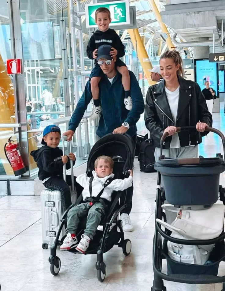 Family with luggage and a stroller arriving at Paris CDG airport